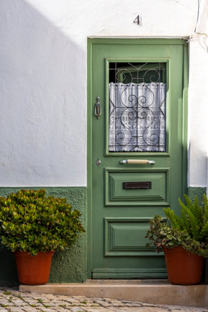 Beautiful green Portuguese door located in the city of Albufeira, Portugal.の写真素材
