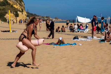 ALBUFEIRA, PORTUGAL - 7th MAY 2024: Group of women doing a bachelorette party in a beach in Albufeira, Portugal.のeditorial素材