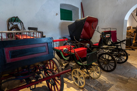 SAO BRAS DE ALPORTEL, PORTUGAL - 6th MAY 2024: Close view of several types of coaches and carriages in a well preserved exhibit.のeditorial素材