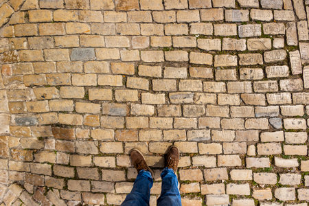LOULE, PORTUGAL - 17th MARCH 2024: Several names, symbols and words on a cobblestone street near the tavern "O Postigo".のeditorial素材