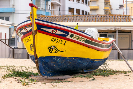 ARMACAO DE PERA, PORTUGAL - 26th MARCH 2024: Traditional Portuguese fishing boat anchored on the...