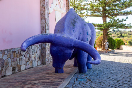 ESTOMBAR, PORTUGAL - 5th OCOTOBER 2024: Artistic plaster modern contemporary purple bull statue located on wine estate "Quinta dos Vales".のeditorial素材