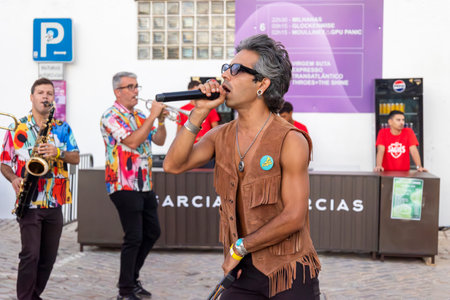 FARO, PORTUGAL: 5th SEPTEMBER, 2024 - Street music group Al-Fanfare performers play in the street at Festival F, a big festival on the city of Faro, Portugalのeditorial素材