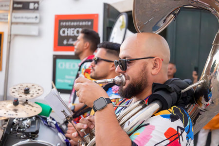 FARO, PORTUGAL: 5th SEPTEMBER, 2024 - Street music group Al-Fanfare performers play in the street at Festival F, a big festival on the city of Faro, Portugalのeditorial素材