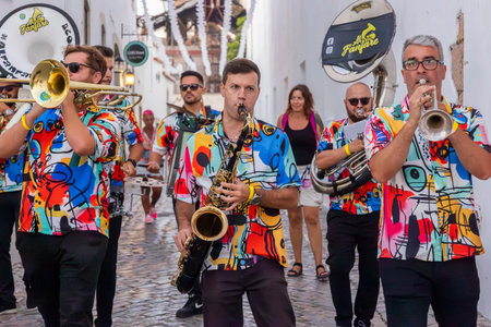 FARO, PORTUGAL: 5th SEPTEMBER, 2024 - Street music group Al-Fanfare performers play in the street at Festival F, a big festival on the city of Faro, Portugalのeditorial素材