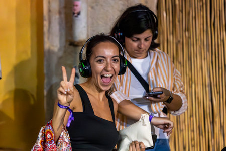 FARO, PORTUGAL: 5th SEPTEMBER, 2024 - Audience enjoying music in headphones on Festival F, a silent disco concept.のeditorial素材