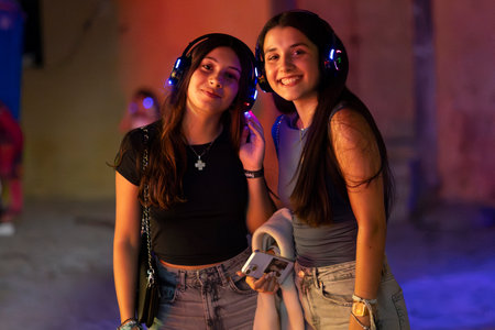 FARO, PORTUGAL: 5th SEPTEMBER, 2024 - Audience enjoying music in headphones on Festival F, a silent disco concept.のeditorial素材