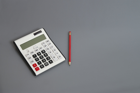 white calculator and pencil on office deskの写真素材