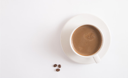 coffee cup and coffee beans on white tableの写真素材