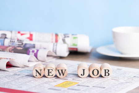 New job on the stack of newspapersの写真素材