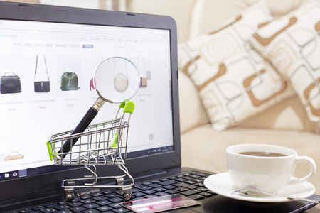 miniature shopping cart on laptopの写真素材