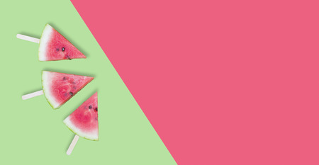 three watermelon slice on green and red background with stickの写真素材