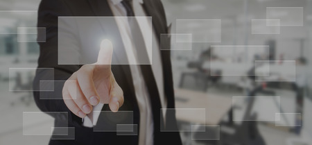 man touching transparent rectangle on the digital screen at the officeの写真素材