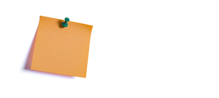 orange note paper fastened to the wall