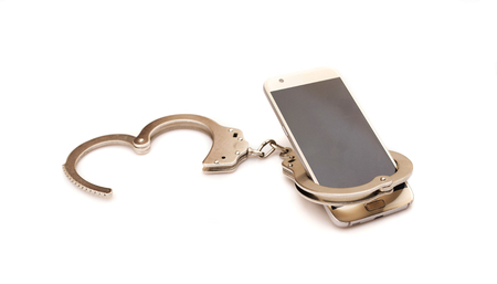 phone and handcuffs. internet,technology and social media addiction conceptの写真素材