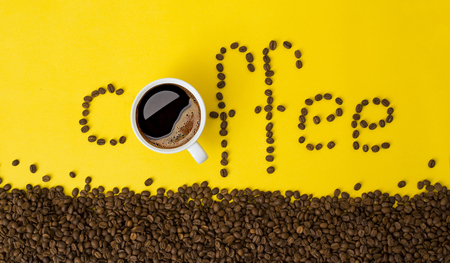 coffee word and coffee cup on yellow background with coffee beansの写真素材