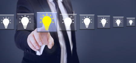 suit businessman touch yellow bright bulb on transparent screen