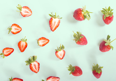 strawberry slice pattern on the green colorful backgroundの写真素材