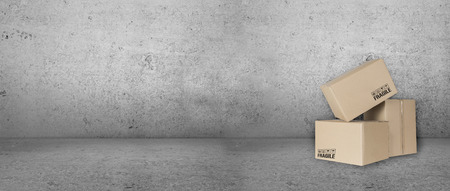 parcels in front of gray empty wallの写真素材