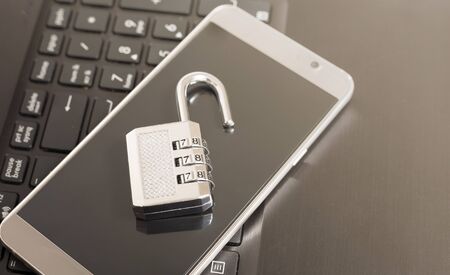 metallic lock on keyboard and phone open case, password security concept