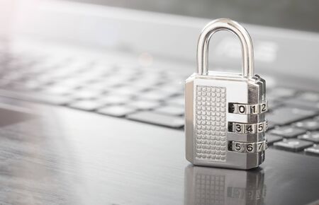 silver combination lock on keyboard.cyber security conceptの写真素材
