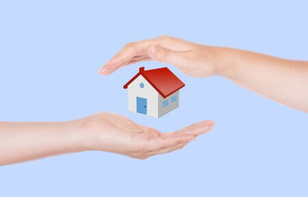 two hands protecting houseの写真素材