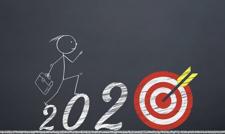 man reaching the target by pressing the numbers 2020. new year career concept