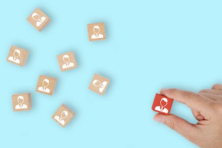 business woman chooses staff leader on wooden cubeの写真素材