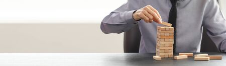 businessman lining up wooden blocks in a row on the table in office. Growth concept in business