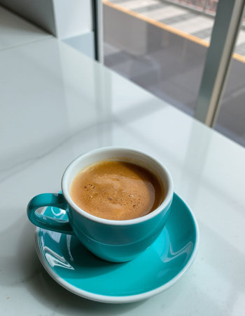 Coffee cup on the table in coffee shop, stock photo