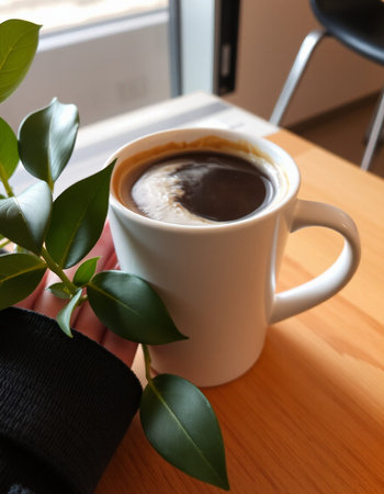 Coffee cup with black scarf on the table in coffee shop