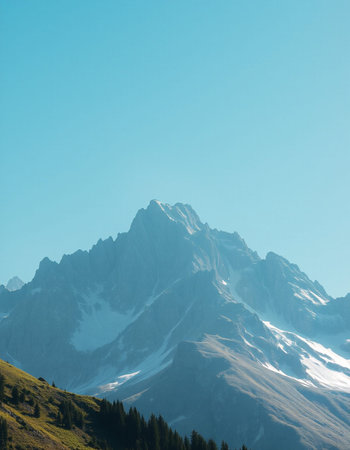 Mountain landscape with snow and clear blue sky.