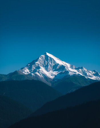Beautiful mountain landscape with clear blue sky and snow-capped peaksの写真素材