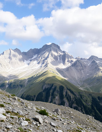 Mountain landscape with snow-capped peaks in the clouds.の写真素材