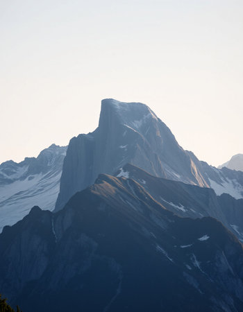 Mountain landscape with snow and clear blue sky.