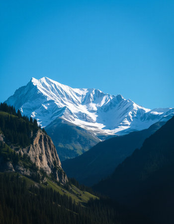Beautiful mountain landscape with snow-capped peaks and blue skyの写真素材