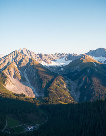Mountain landscape with snow-capped peaks in the evening.の写真素材