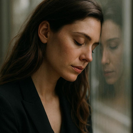 Portrait of a beautiful young woman in a black suit, looking through the window.の写真素材