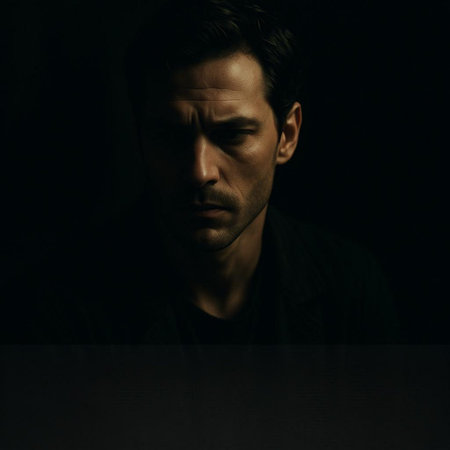 Portrait of a young man in a dark room on a dark background