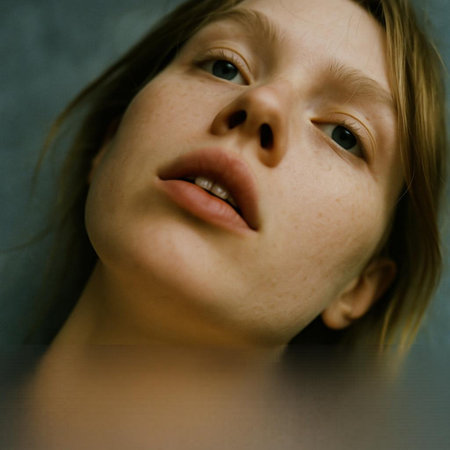 Portrait of a young girl with freckles on her face