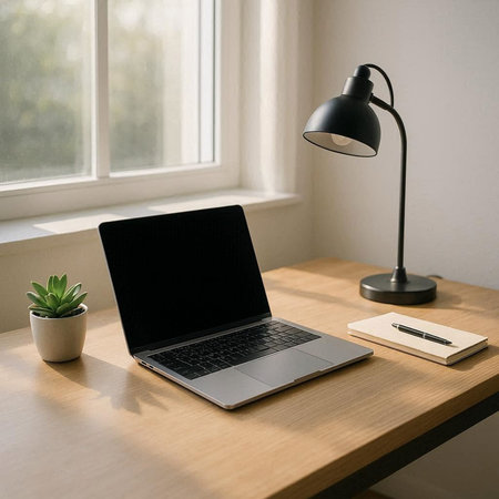 laptop with blank screen on table in office room, stock photo