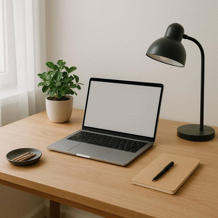 Laptop with blank screen on wooden table in office, stock photo