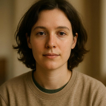 Portrait of a young man with long hair in a beige sweater