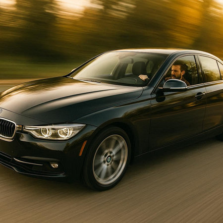 A man driving a car on a forest road. Motion blur.