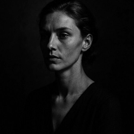 Black and white portrait of a young woman in a black dress.