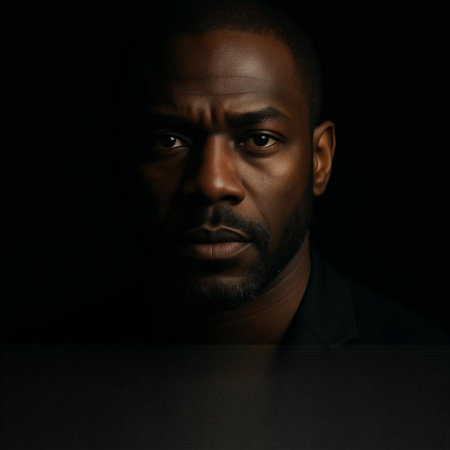 Portrait of a young African-American man on a dark background