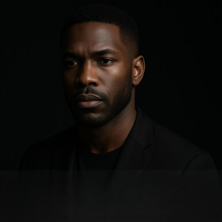 Portrait of a handsome african american man against black backgroundの写真素材