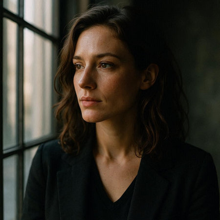 Portrait of a beautiful woman in a black jacket, looking at the camera.の写真素材