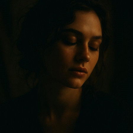 Portrait of a beautiful girl with closed eyes on a dark backgroundの写真素材