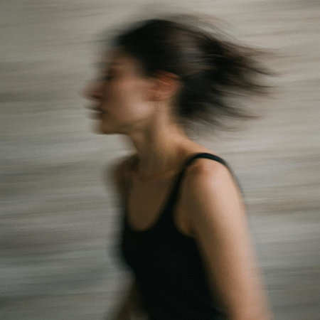A young woman in a black dress in motion blur. Motion blur.の写真素材